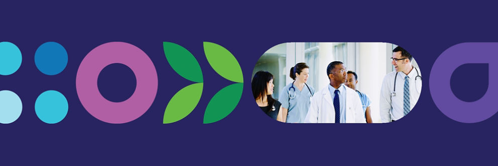 A diverse group of doctors smile toward the camera.