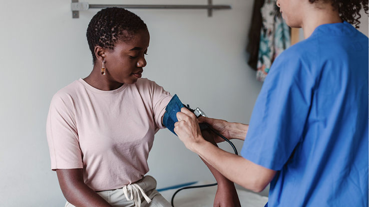A woman gets her blood pressure taken.