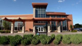 A picture of the entrance to HealthPartners Riverway Clinics. It is a welcoming building surrounded by trees and other landscaping.