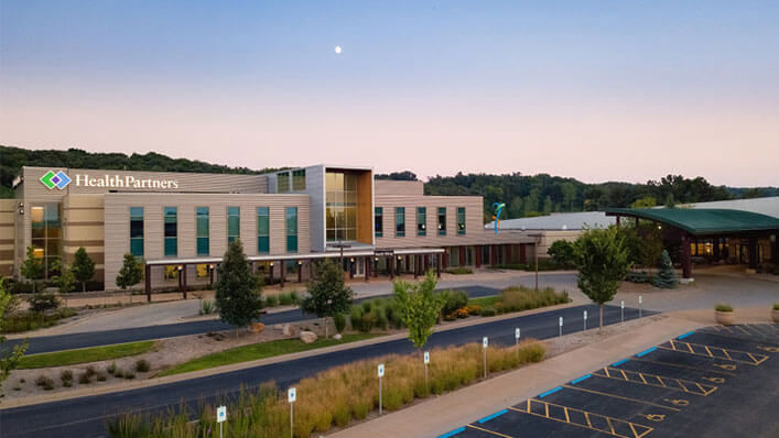 Hudson Hospital and Clinic with a welcoming entrance and ample parking. 