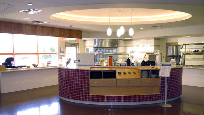 Dining area with different cafeteria lines that serve a variety of foods.