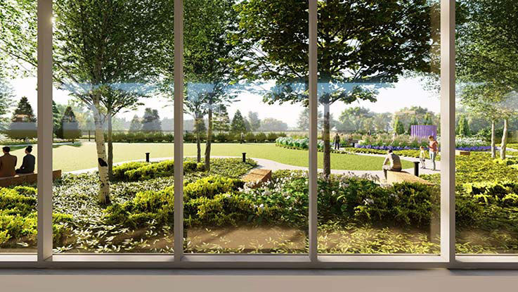 A view of the green space around the hospital, as seen through floor-to-ceiling windows.