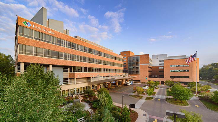 An overhead view of Methodist Hospital & Clinic and the parking lot on a clear, bright day.