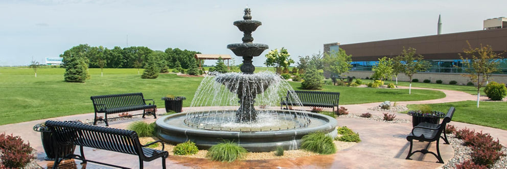 A serene fountain outside the main entrance of Olivia Hospital & Clinic.