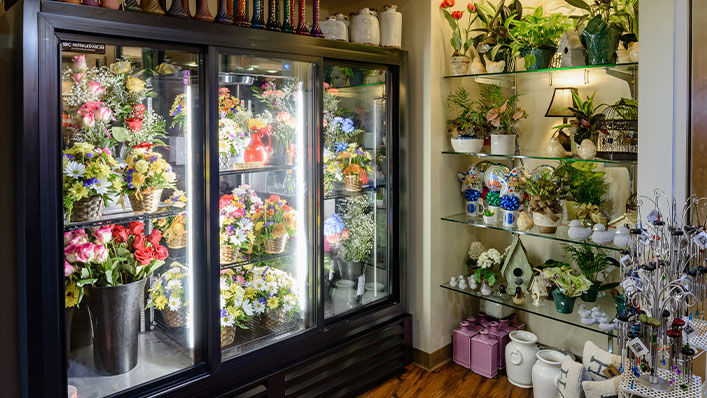 Bright flowers line gift shop shelves.