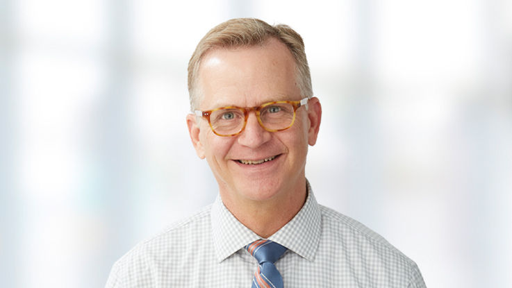 Portrait of Anthony Grundhauser, a smiling white man with light hair.