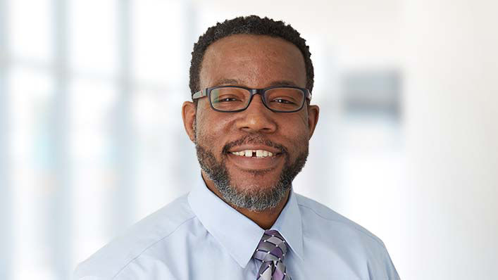 A portrait image of Dr. Steven Jackson, a Black man, smiling