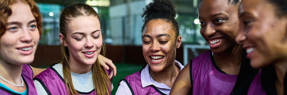 A woman’s sports team huddle.