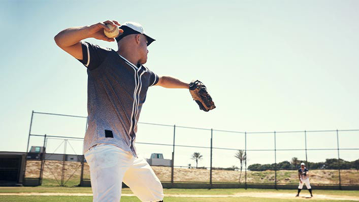 A young man pitching a ball during a baseball game.