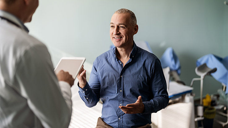 A man talking with a physical therapist.