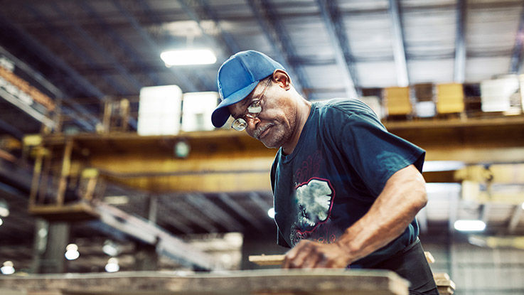 A carpenter works in a warehouse