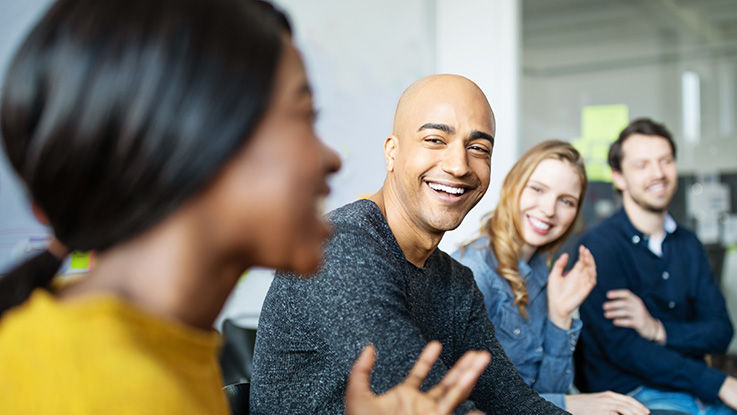 People sitting around a table talking about how they can support the foundation.