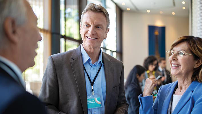 Council Diverse business professionals chat during an event.