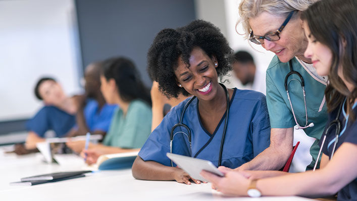 Medical residents share notes during a class discussion.