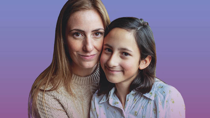 A mother and her preteen daughter with their faces pressed together give small smiles to the camera.