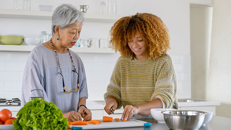 A dietician helping a patient prepare food.