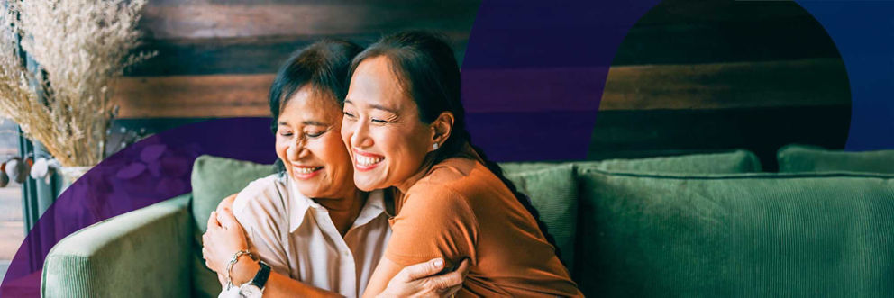 A mother and daughter hold each other and smile