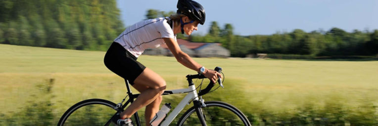 A man stretches his shoulders and back before a run outside.