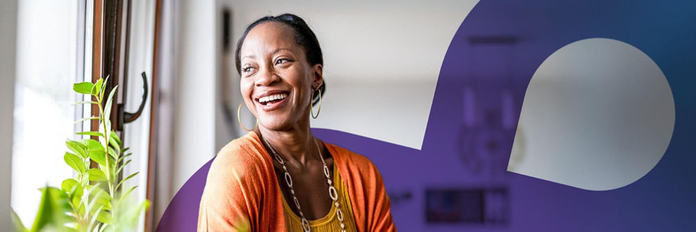 A woman looks out the window and smiles.