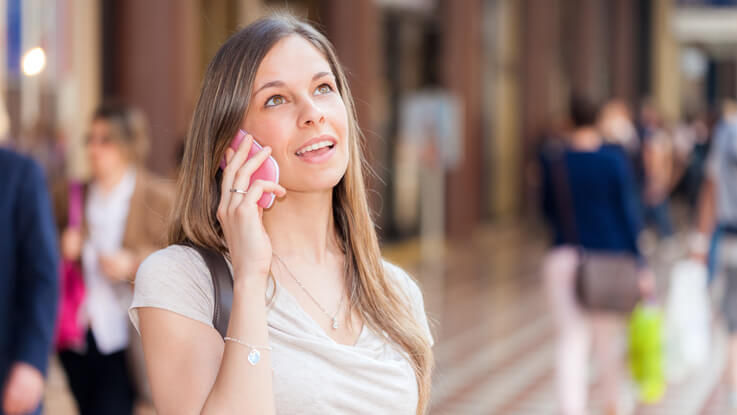 Woman walking and talking on her mobile phone.