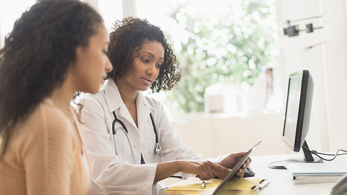 A doctor goes over test results with her patient