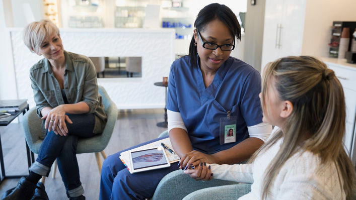 Nurse holding the hands of a patient