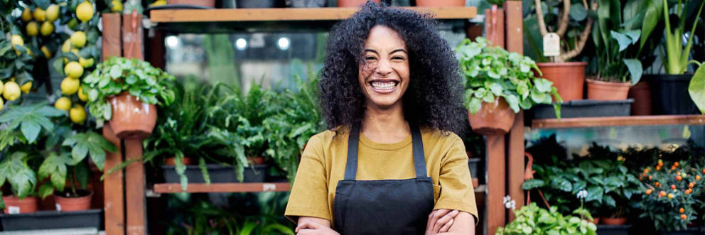 Seasonal allergies, portrait of cheerful owner standing at market stall