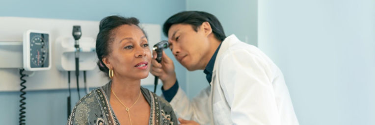 Doctor looking in patient's ear.