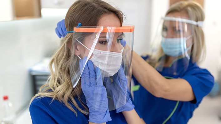 A health care worker wears personal protective equipment.