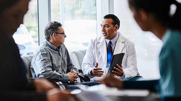  A doctor talks with his client about different care options.