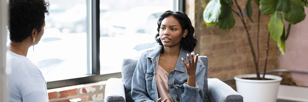 A young woman talks to an eating disorder doctor.