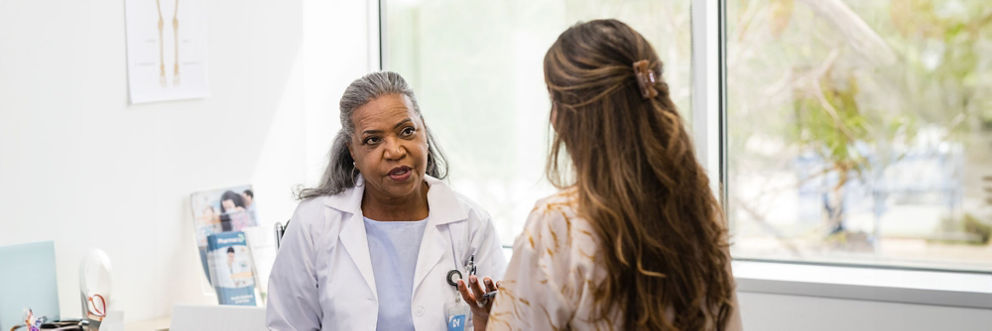 A doctor and patient have a respectful conversation during an office visit.