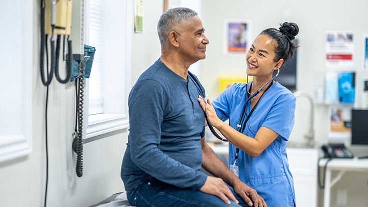 A health care worker selects medicine for a patient