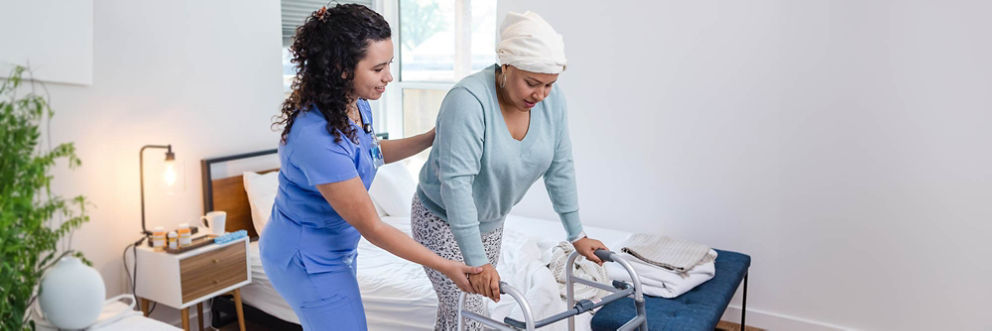 Female physical therapist helps a hospice patient to exercise