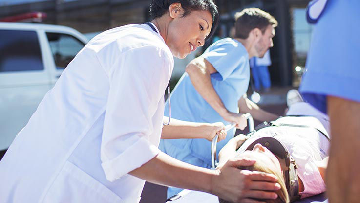 A patient is treated by the emergency care team.