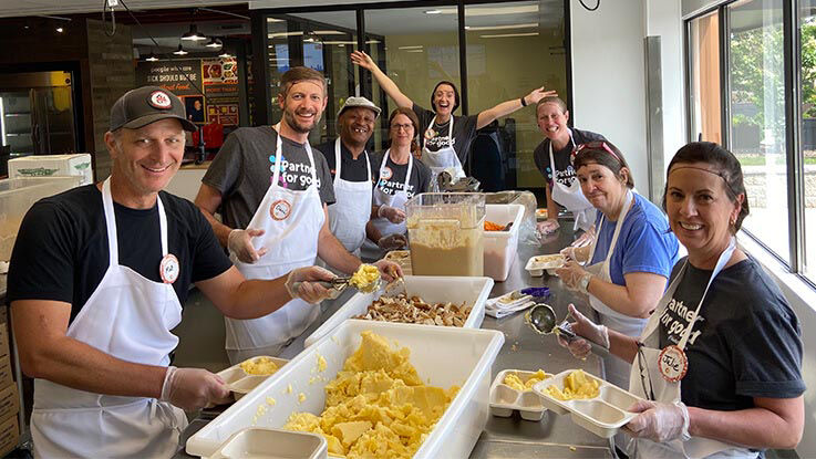 Volunteers from HealthPartners assist in meal preparation for Open Arms.