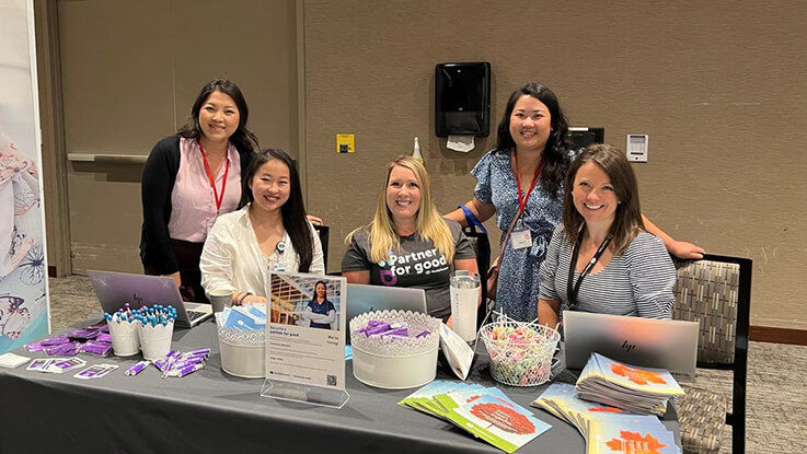 HealthPartners nurses pose for a picture behind their informational table at the Hmong Nurses Association National Conference.