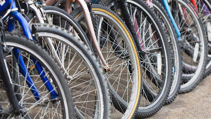 Donated bikes are lined up in a row.