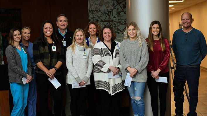 A group of smiling scholarship recipients pose together.