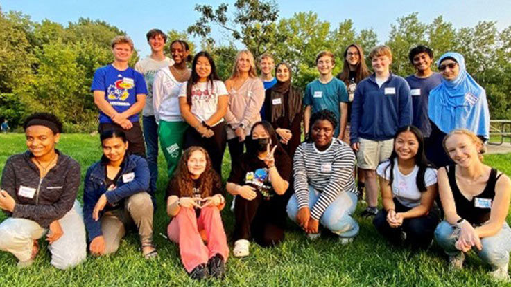 The diverse group of 19 TLC participants pose for a group picture in a local park. 