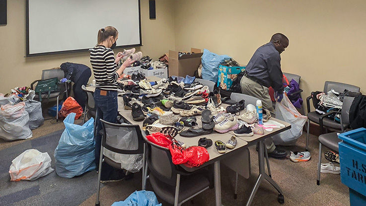 HealthPartners team members sort and bag secondhand shoes for donation.